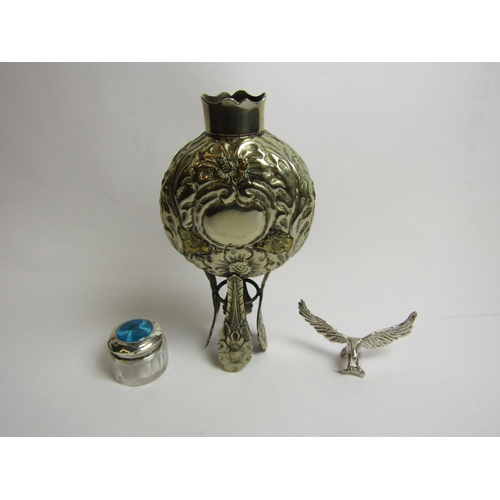 4336 - A white metal embossed vessel, silver lidded glass pot and a model of an eagle with fish in its talo... 