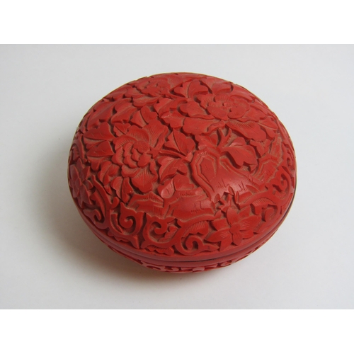 4337 - A cinnabar style lidded pot with carved floral detailing and lacquered interior