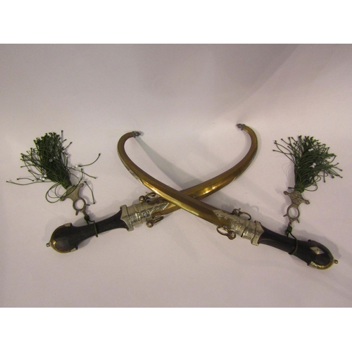 4343 - A pair of Moroccan/North African decorative daggers, both with curved brass blades, engraved mounts