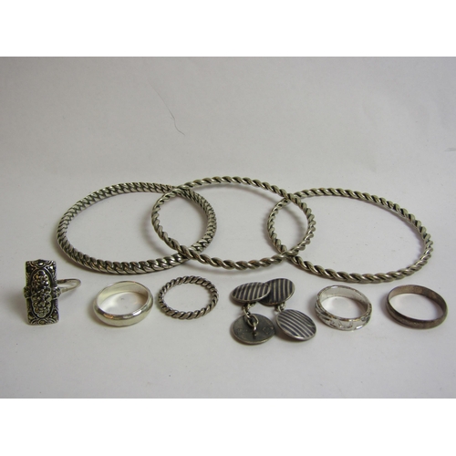 4367 - A selection of silver and white metal including four rings, a pair of cuff links and three bangles