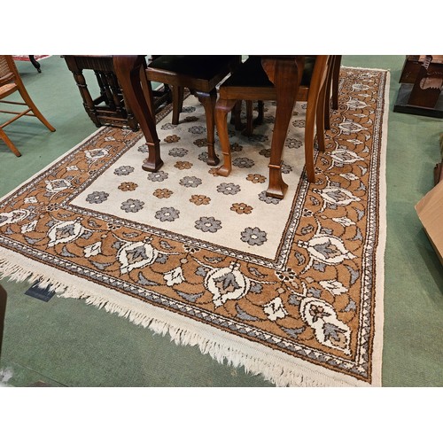 4446 - A brown and beige ground rug, tasselled ends, 270cm x 180cm