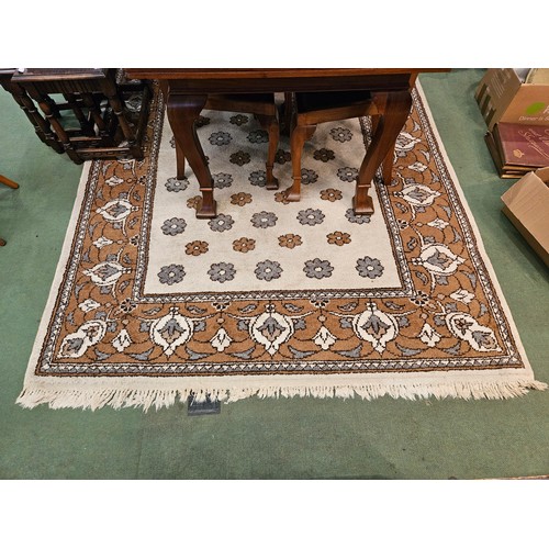 4446 - A brown and beige ground rug, tasselled ends, 270cm x 180cm