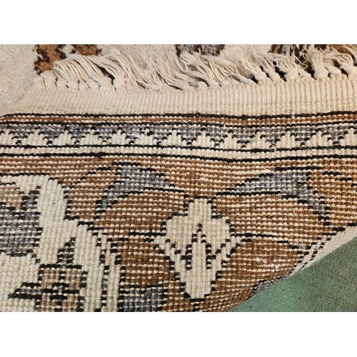 4446 - A brown and beige ground rug, tasselled ends, 270cm x 180cm