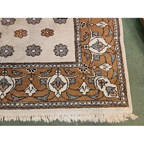 4446 - A brown and beige ground rug, tasselled ends, 270cm x 180cm