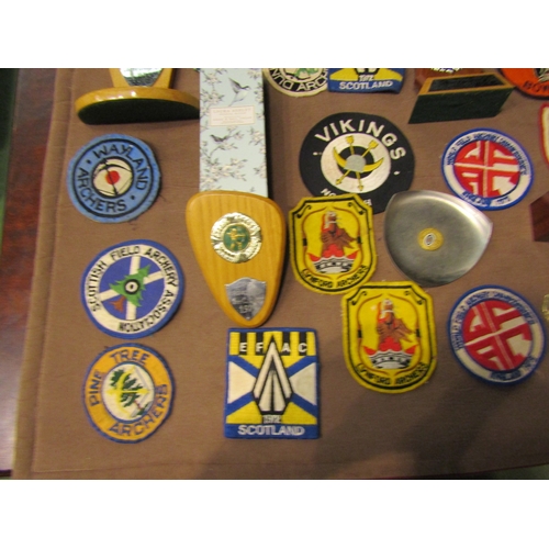 4432 - A box of archery medals, trophies and patches etc.