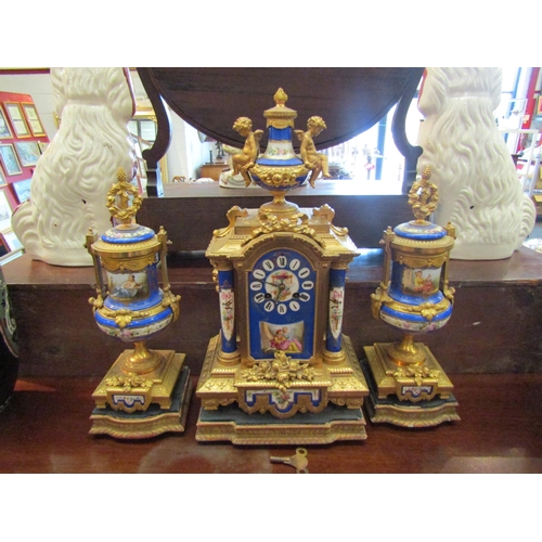 1166 - WITHDRAWN A late 19th Century French porcelain and ormolu three-piece clock garniture, the clock wit... 