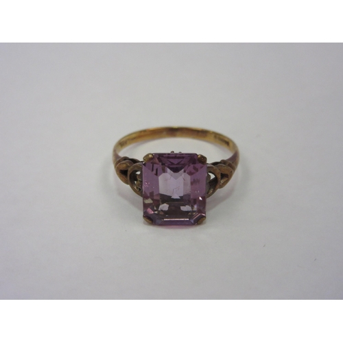 1292 - A gold ring, stamped 375, set with pink facet cut semi-precious stone