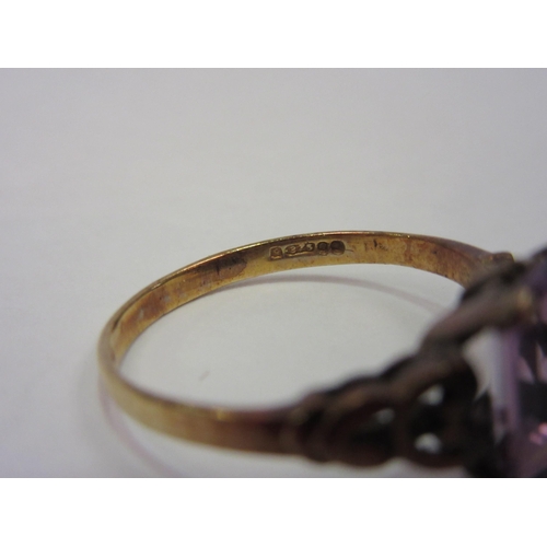 1292 - A gold ring, stamped 375, set with pink facet cut semi-precious stone