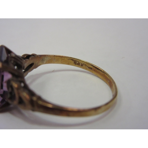 1292 - A gold ring, stamped 375, set with pink facet cut semi-precious stone