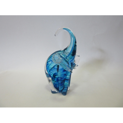 1320 - A blue Art glass elephant form paperweight, etched Kenneth Marine, 17cm tall