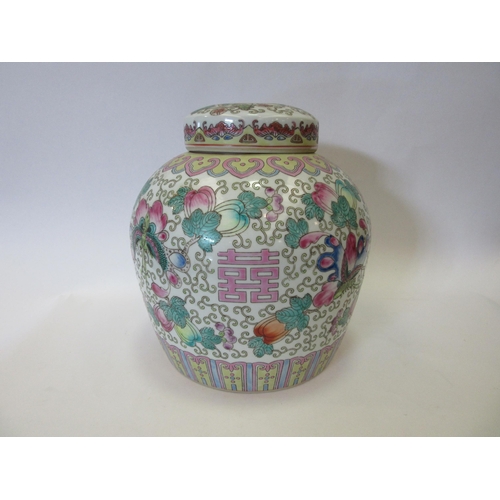 1336 - A Famille Rose ginger jar with flower and butterfly design, with lid having similar design of centra... 