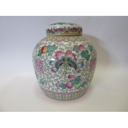 1336 - A Famille Rose ginger jar with flower and butterfly design, with lid having similar design of centra... 