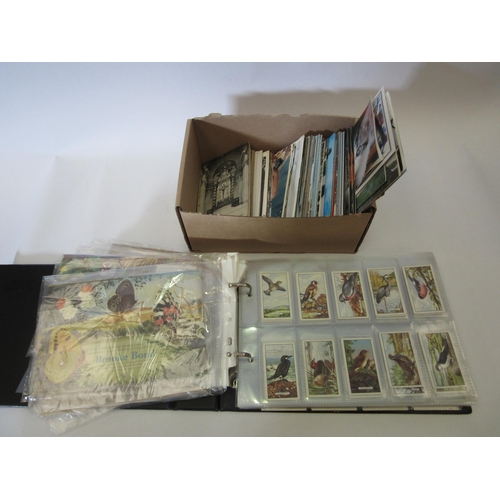 1341 - A box of mixed postcards and an album containing sets of cigarette cards