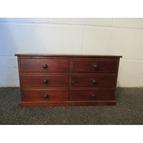 1001 - An early 20th Century nest of six stained pine collector's drawers, with bakelite knob handles, 26.5... 