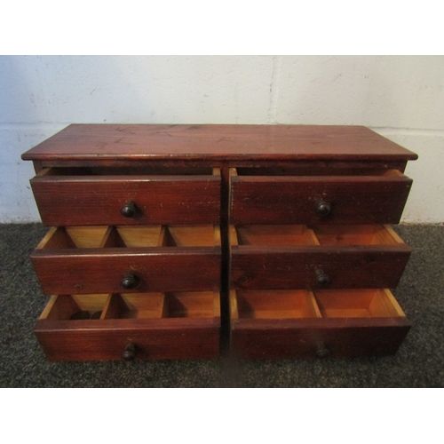 1001 - An early 20th Century nest of six stained pine collector's drawers, with bakelite knob handles, 26.5... 