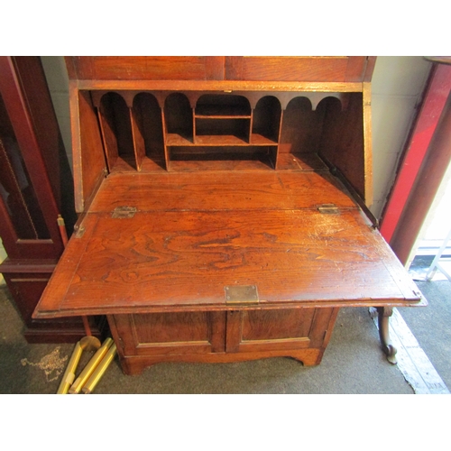 1005 - A 1920's oak full height bureau bookcase, the lead glazed top over base with fall front over a singl... 