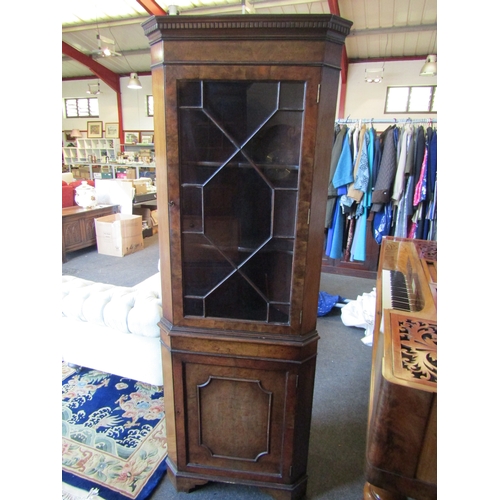 1007 - A veneered corner cabinet with astragal glazed top (crack to glass) over a cupboard door on bracket ... 