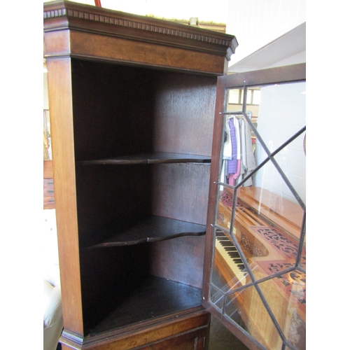 1007 - A veneered corner cabinet with astragal glazed top (crack to glass) over a cupboard door on bracket ... 