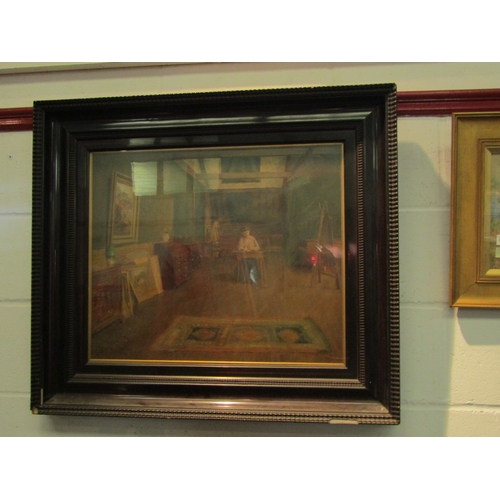 1022 - An early 20th Century oil on board depicting a female artist in her studio, framed and glazed, 51cm ... 