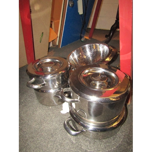 1030 - Four AGA lidded pans, a stainless steel colander and an Artame lidded cooking pot (6)