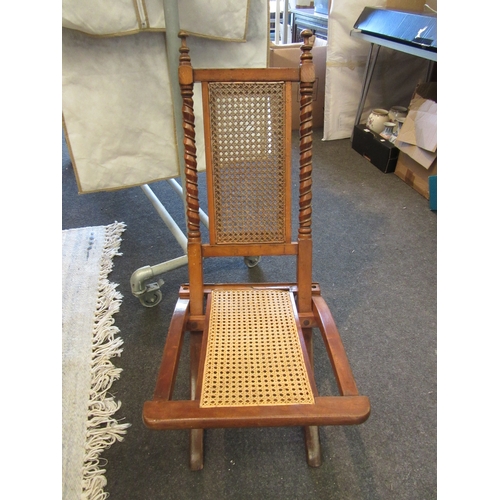 1087 - A bergere folding chair together with an Edwardian bedroom chair, inlaid with satinwood to back spla... 