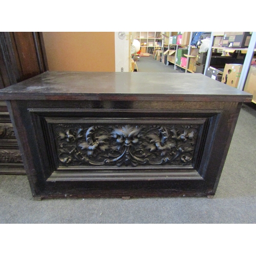 1119 - A small dark stained oak chest with carved front and back panels, 44cm tall x 74cm wide x 40cm deep