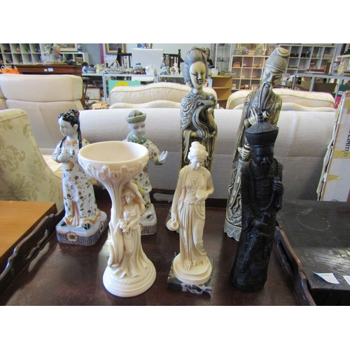 1122 - Seven ceramic and resin Eastern figures, tallest 39cm