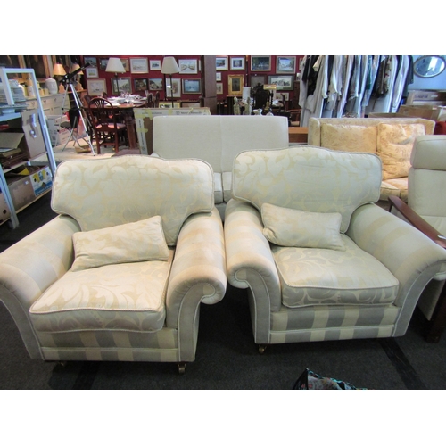 1139 - A pair of modern armchairs with scroll arms and wavy backs, brass castors to fore legs, stained and ... 