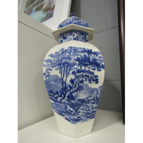 1263 - A pair of blue and white lidded urns with lion finials (one lion a/f), 34cm tall