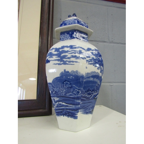 1263 - A pair of blue and white lidded urns with lion finials (one lion a/f), 34cm tall