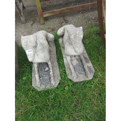 8058 - A pair of composition recumbent dogs, approx 27