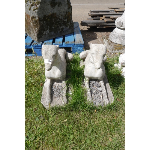 8058 - A pair of composition recumbent dogs, approx 27