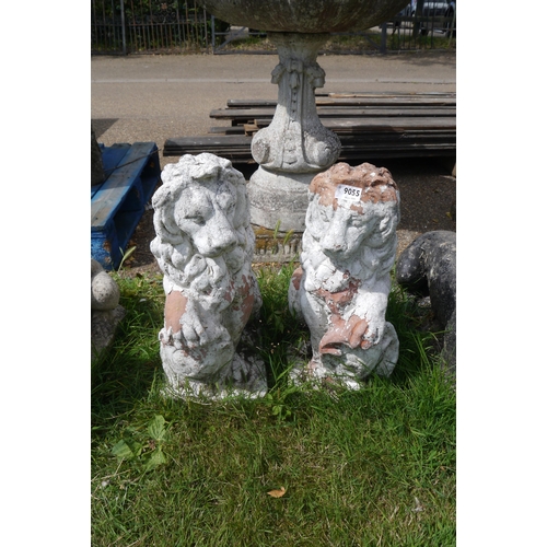 8055 - A pair of weathered terracotta seated lions, 20