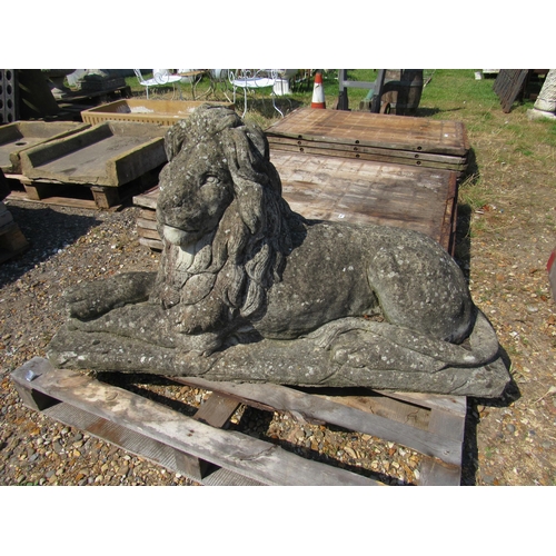 8029 - A weathered composition recumbent lion, damage to back corner, 50