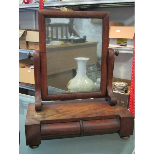 1163 - A Victorian mahogany swing toilet mirror of small proportions, with cushion-moulded drawer (a/f)