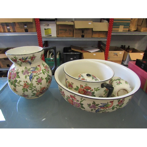 1170 - A five piece ceramic wash set decorated with birds among foliage, chip to rim of jug and crack to li... 