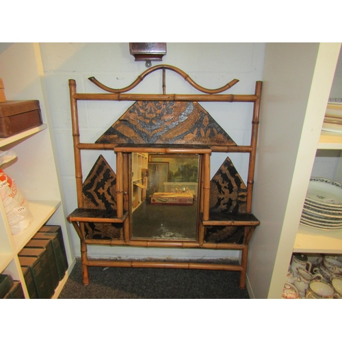 1379 - A faux bamboo wall mirror with black and gilt detailing and shelves, 98cm tall x 76cm wide