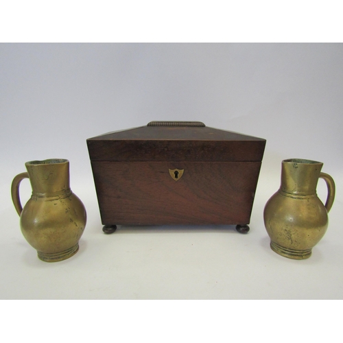 1403 - A sarcophagus tea caddy and a pair of heavy brass jugs (3)