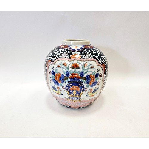 1120 - A navy blue ginger jar with orange flower pattern design with two panels depicting a floral display ... 