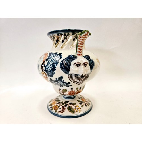 1346 - A Dutch Makkum Delft faience vase with twin masks, panel with windmill scene, floral detailing and l... 