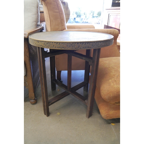 2214 - A 1930's Oriental brass top folding table with Tigers head design