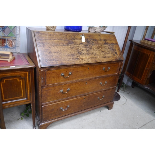 2236 - A Georgian oak bureau with fitted interior