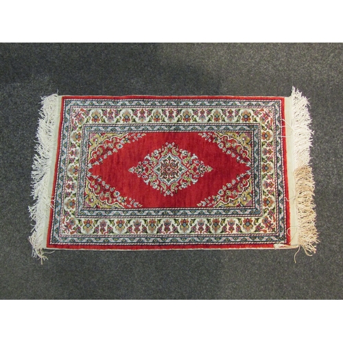 1098 - A Kayseri silk red ground prayer mat. 65cm x 44 cm