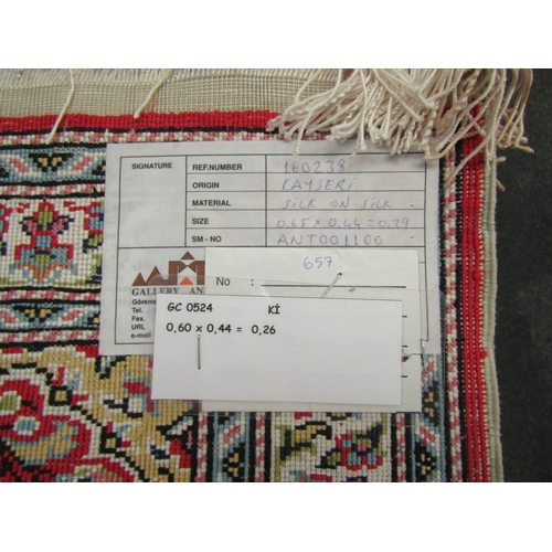 1098 - A Kayseri silk red ground prayer mat. 65cm x 44 cm