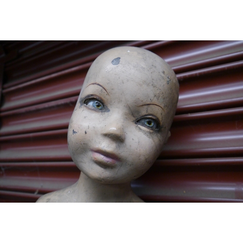 2074 - A child mannequin with glass eyes, armless