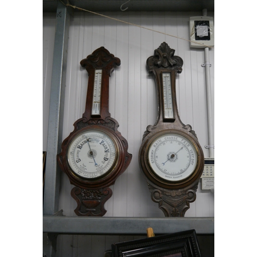 2096 - Two carved oak barometers