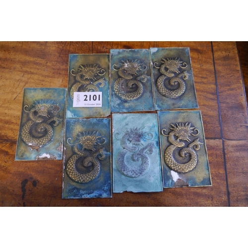 2101 - Seven weathered brass dragon plaques