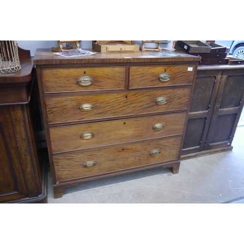 2102 - A George III mahogany chest of two short over three long drawers, brass oval plate handles, bracket ... 