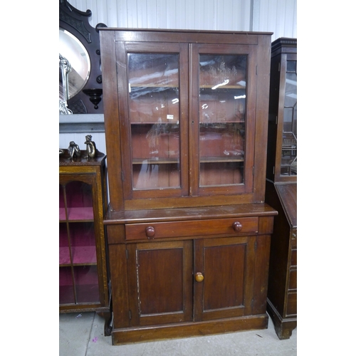 2124 - A Victorian mahogany glazed bookcase over two door cupboard and single drawer