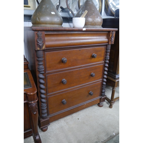 2136 - A Victorian mahogany four drawer chest of drawers on bun feet and twist details